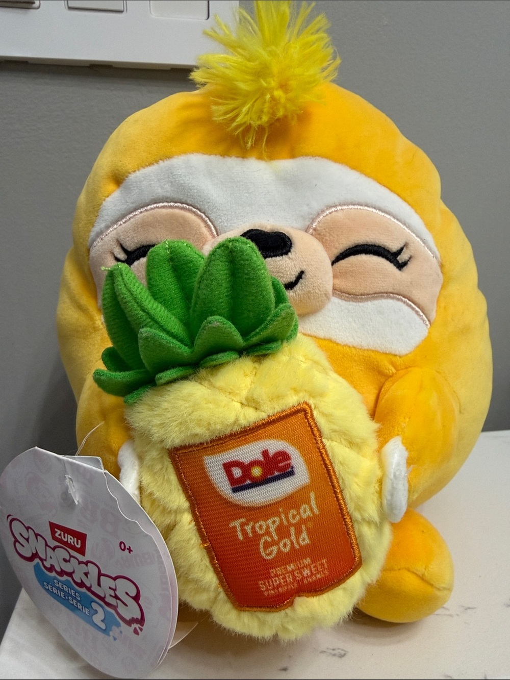 ZURU Squishmallows-Style Yellow Plush Holding Dole Pineapple